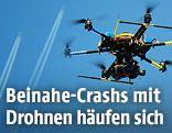 Drohne, im Hintergrund zwei Flugzeuge