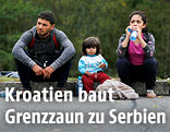 Flüchtlingsfamilie sitzt am Randstein
