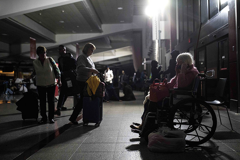 Frau in Rollstuhl sitzt im Dunklen auf dem Flughafen Atlanta